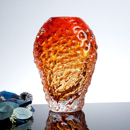 Front view of amber textured glass vase with blue flowers