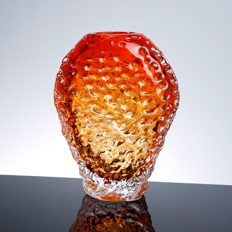 Front view of amber textured glass vase on reflective surface