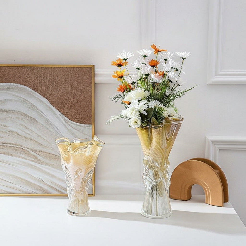Amber and white swirl glass vase with flowers on table