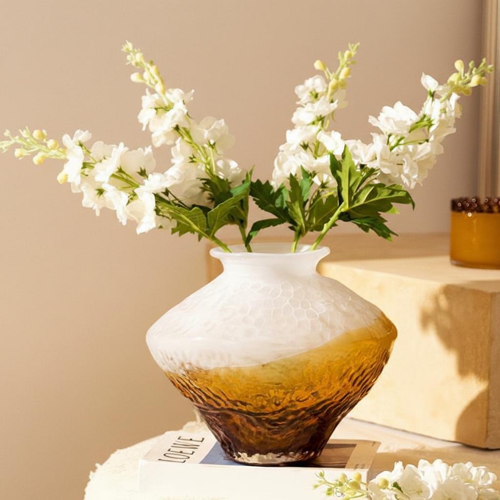 Close up of amber and white gradient vase with white flowers
