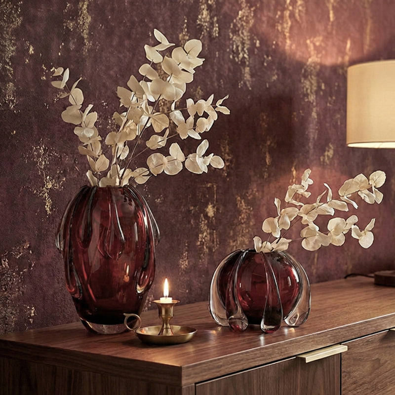 Set of two purple crystal vases on wooden console