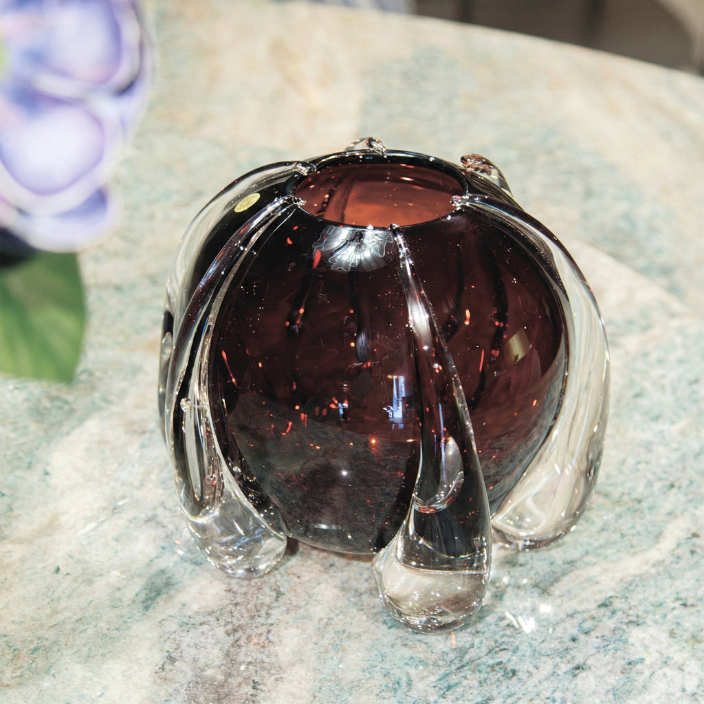 Medium round purple crystal vase on surface