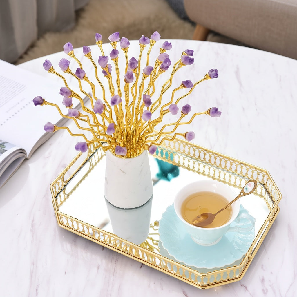 Amethyst and gold metal sculpture displayed on a gold mirrored tray