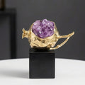 Front view of gold pomegranate sculpture with amethyst crystals