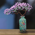Front view of amethyst and jade copper wire bonsai in teal ceramic vase