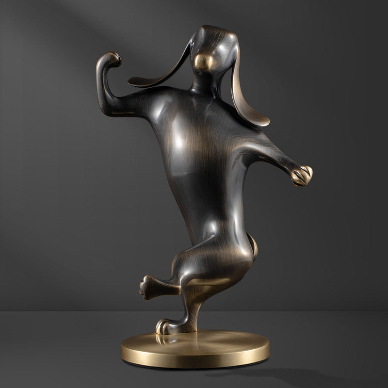 Front view of dancing dog sculpture in antique brass
