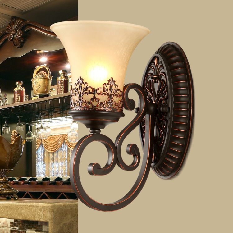 Front view of antique bronze wall sconce with frosted glass shade