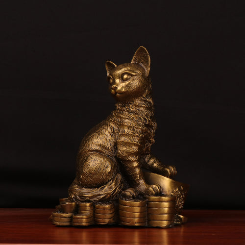 Front view of antique copper cat sculpture on coins