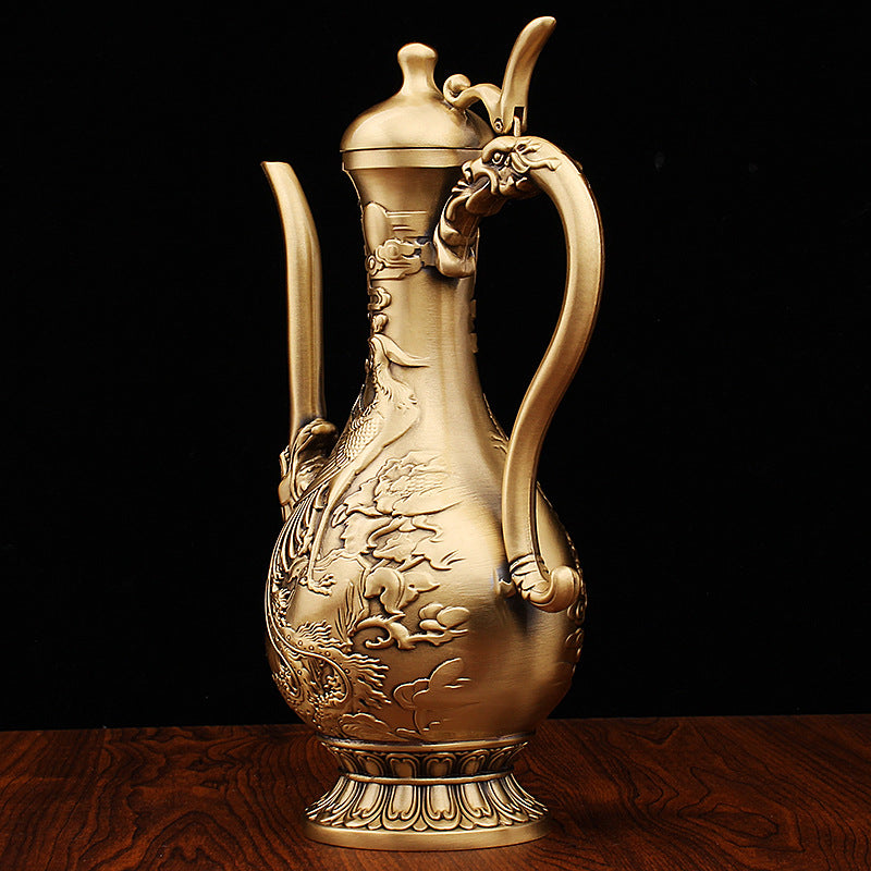 Side view of antique copper teapot featuring phoenix relief