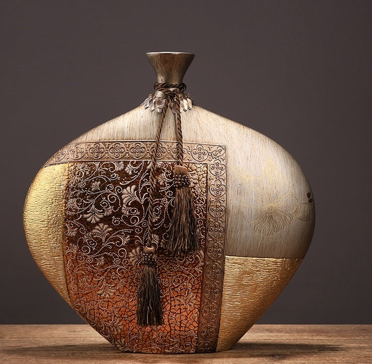 Wide antique gold vase with intricate floral patterns