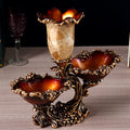 Front view of antique gold resin centerpiece with vase and two bowls