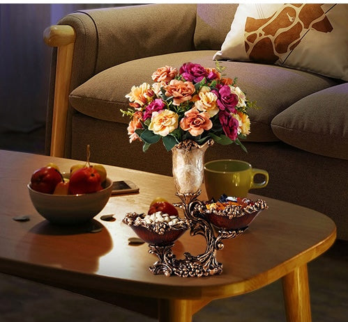Lifestyle shot of centerpiece on coffee table with flowers and snacks