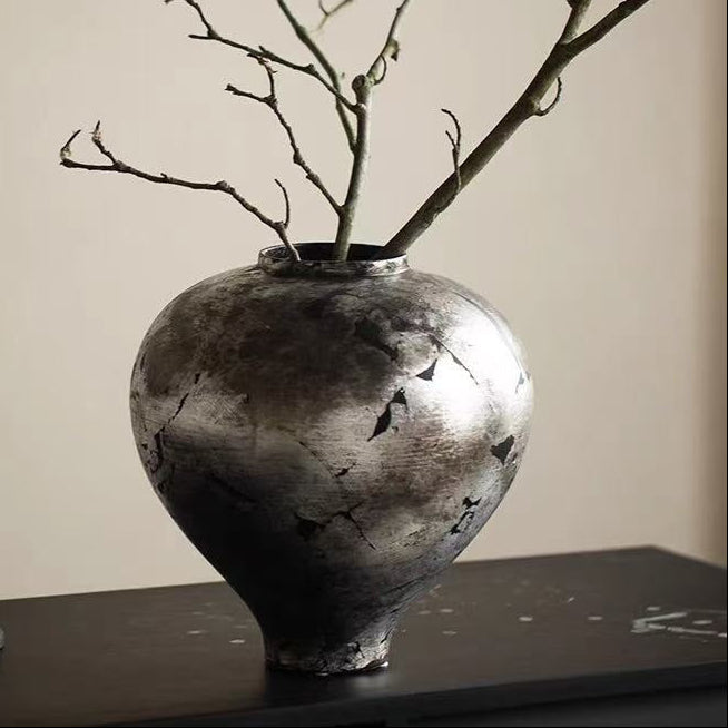 Close up of silver ceramic vase texture with dry branches