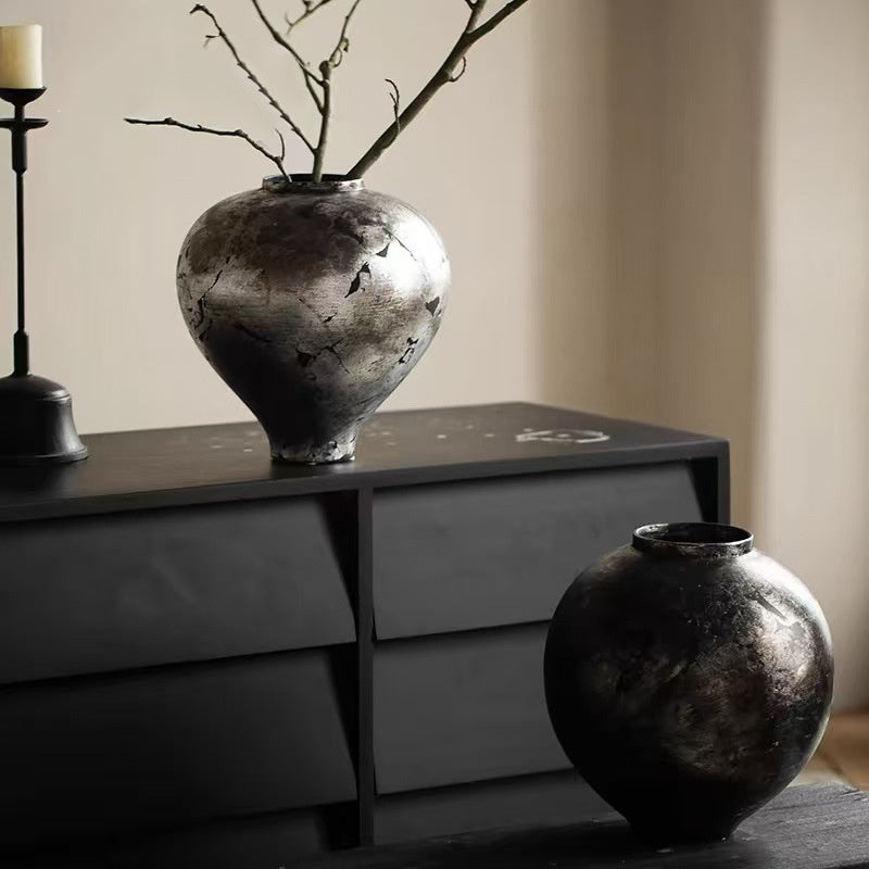 Two metallic finish ceramic vases styled together