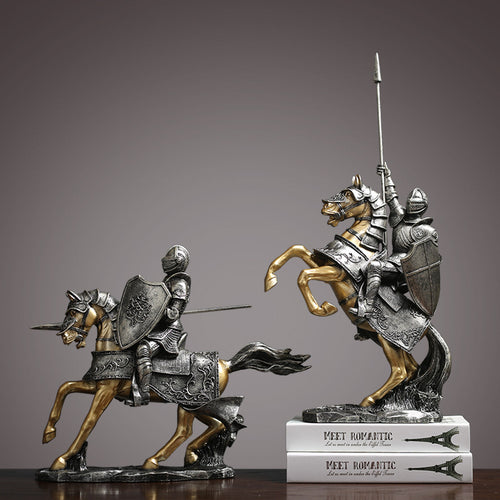 Two medieval knight figurines in silver and gold resin displayed together
