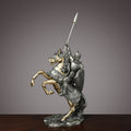 Rearing knight statue in antique silver armor on gold horse