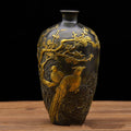 Front view of antiqued copper vase with gold bird relief