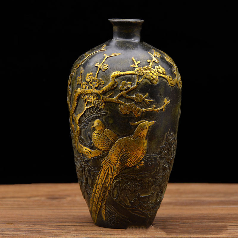 Front view of antiqued copper vase with gold bird relief