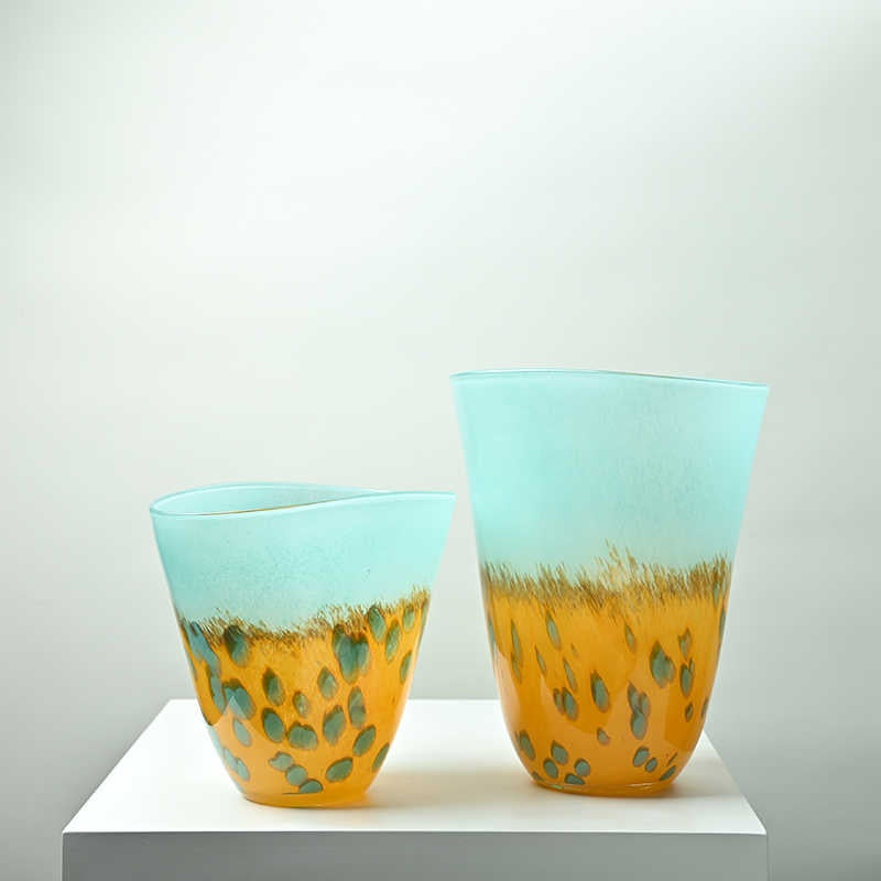 Two tone aqua and amber glass vases side by side