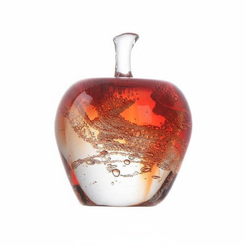 Close up of red amber art glass apple with internal bubbles