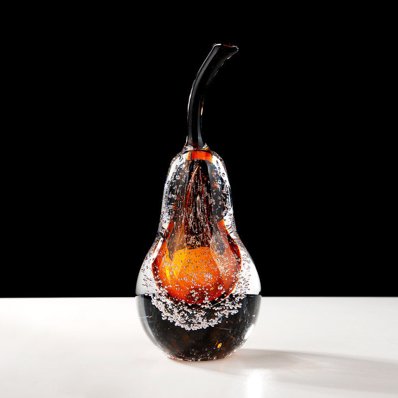 Amber glass pear sculpture with suspended bubbles