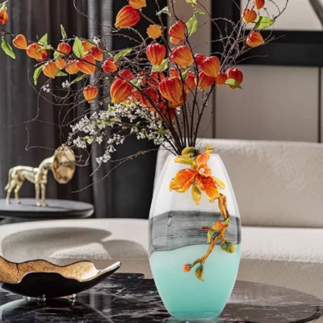 Gradient glass vase with orange floral arrangement