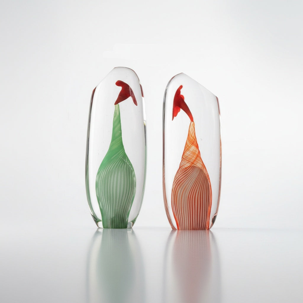 Two art glass teardrop sculptures in green and red