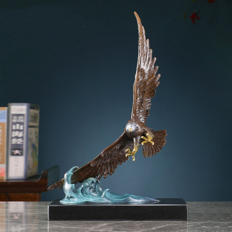 Front view of handcrafted brass eagle statue with polished talons and beak