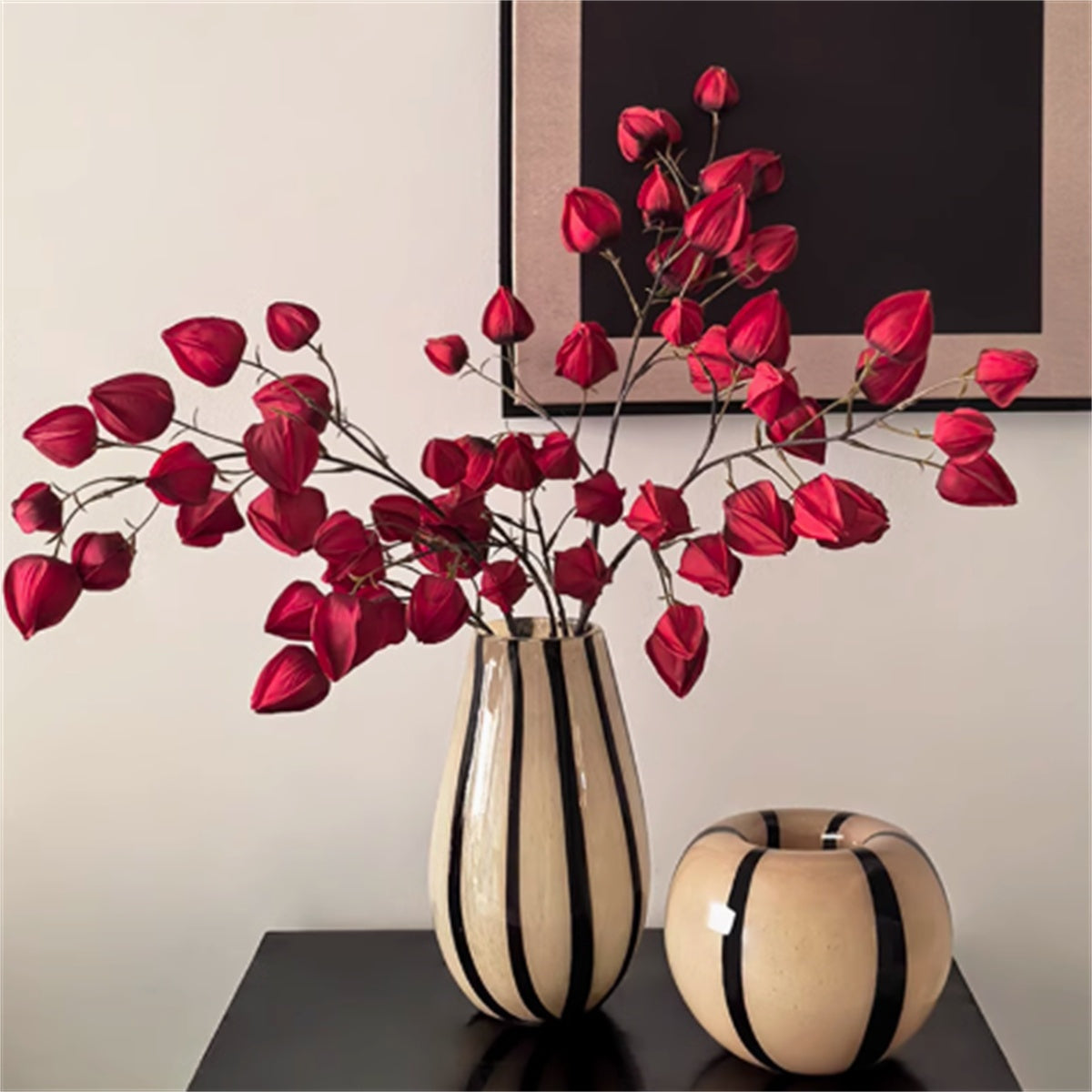 Beige and black striped glass vases with red flowers