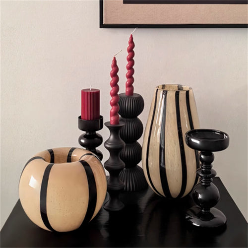 Striped glass vases styled with black candle holders