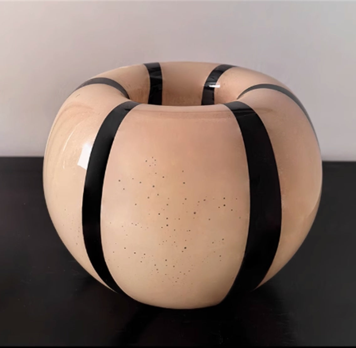 Top view of round beige and black striped glass vase
