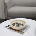 Beige cave stone round decorative bowl on coffee table