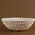 Side view of beige beaded texture ceramic bowl