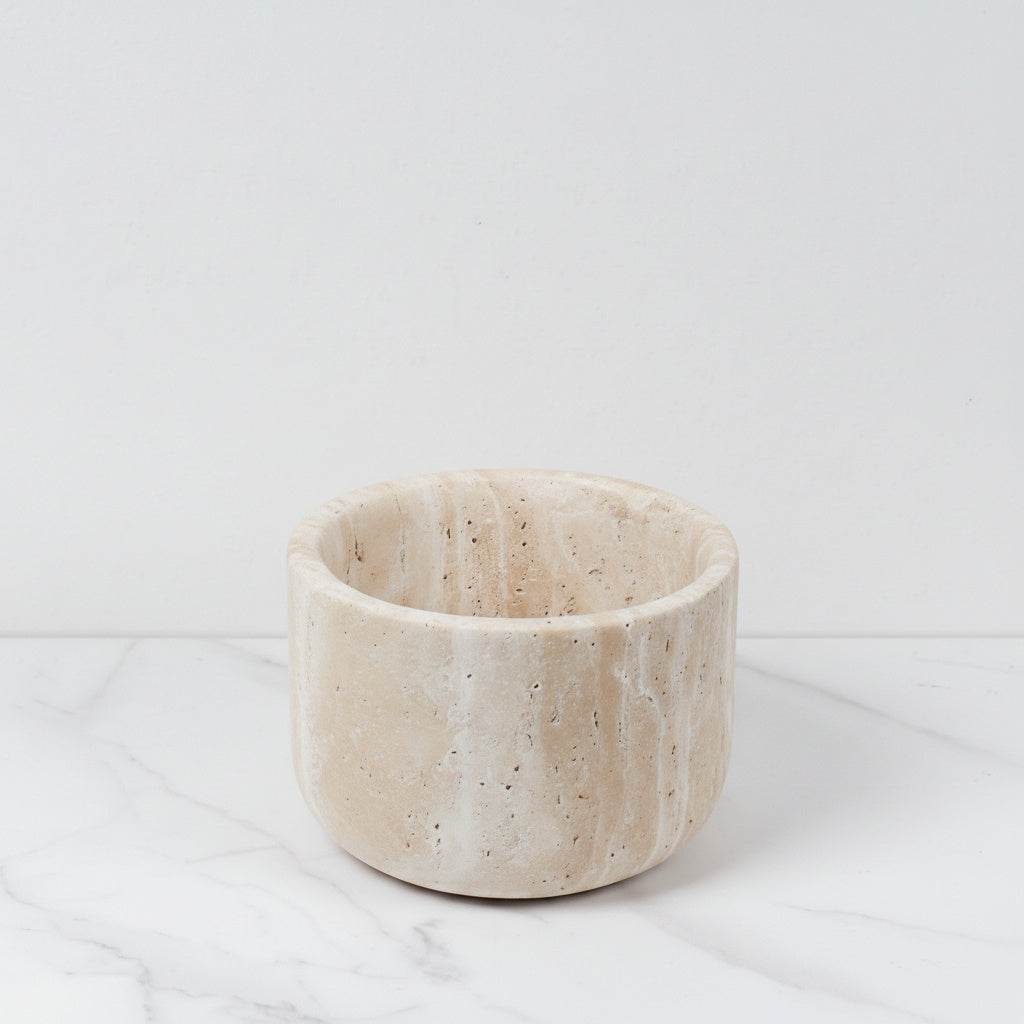 Empty wide beige travertine marble bowl on white surface