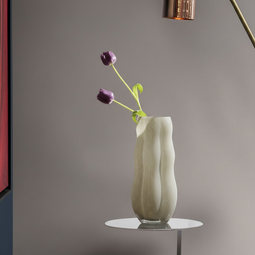 Detail of wavy beige glass vase rim with purple flowers