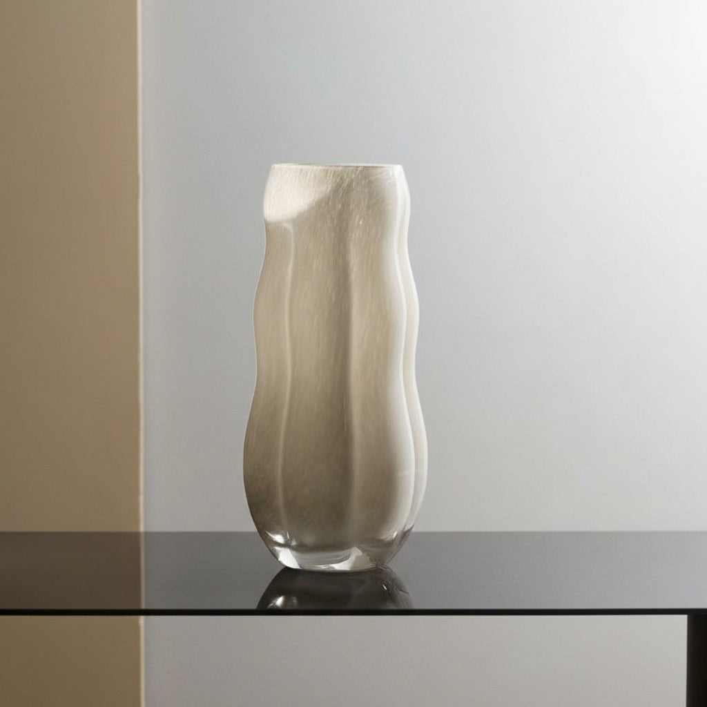 Empty beige wavy glass vase showing organic silhouette