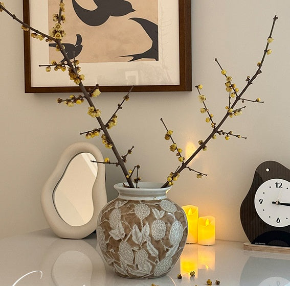 Ceramic vase styling with branches on white table