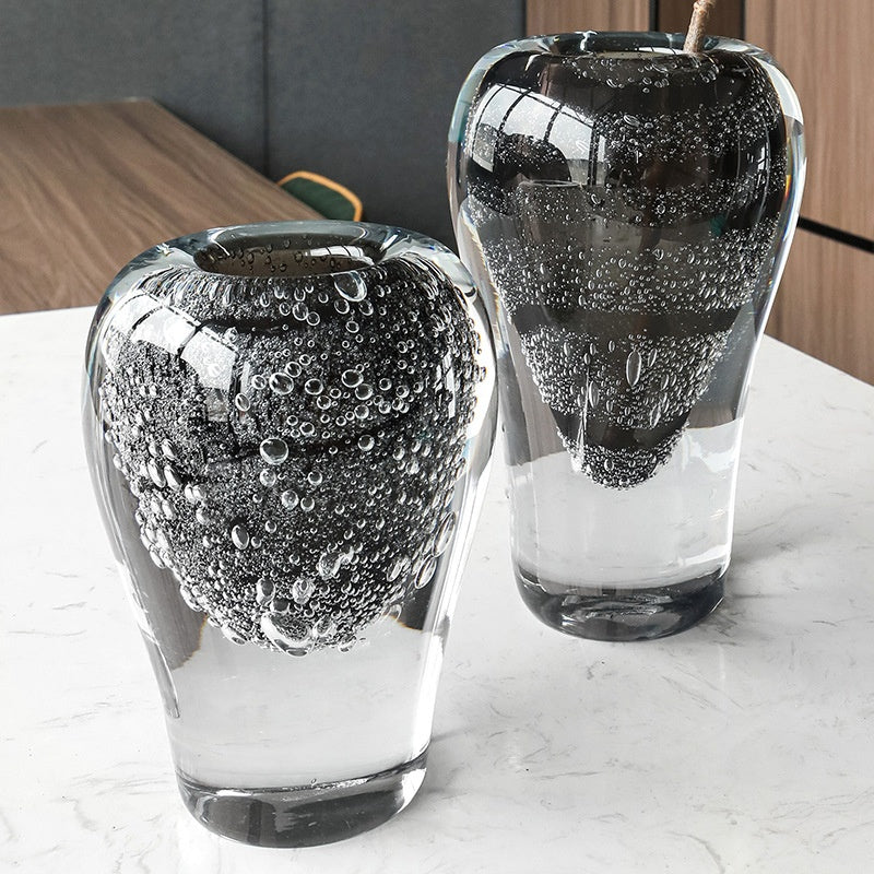 High angle view of large and medium black bubble glass vases