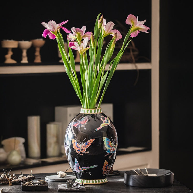 Butterfly motif vase with flowers in a luxury setting