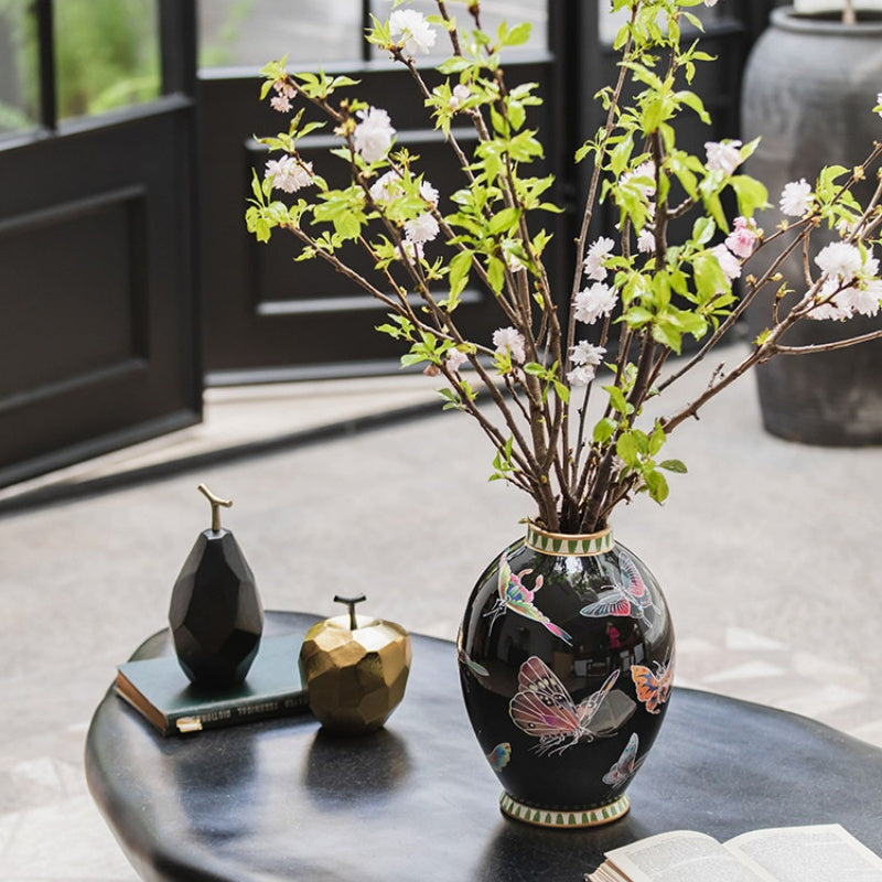 Lifestyle shot of black ceramic vase on coffee table