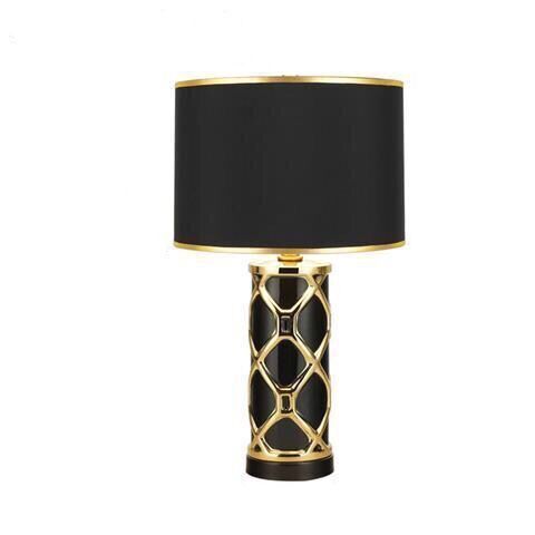 Front view of black ceramic lamp with gold geometric cage base