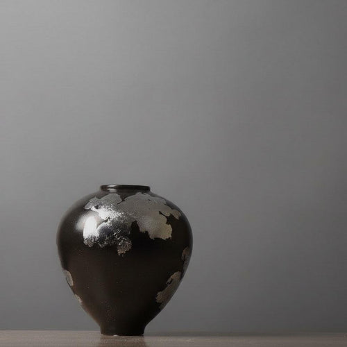 Black ceramic vase with gold metallic abstract details
