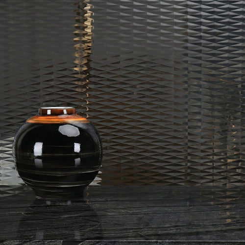Large ribbed black ceramic vase with bronze rim detail