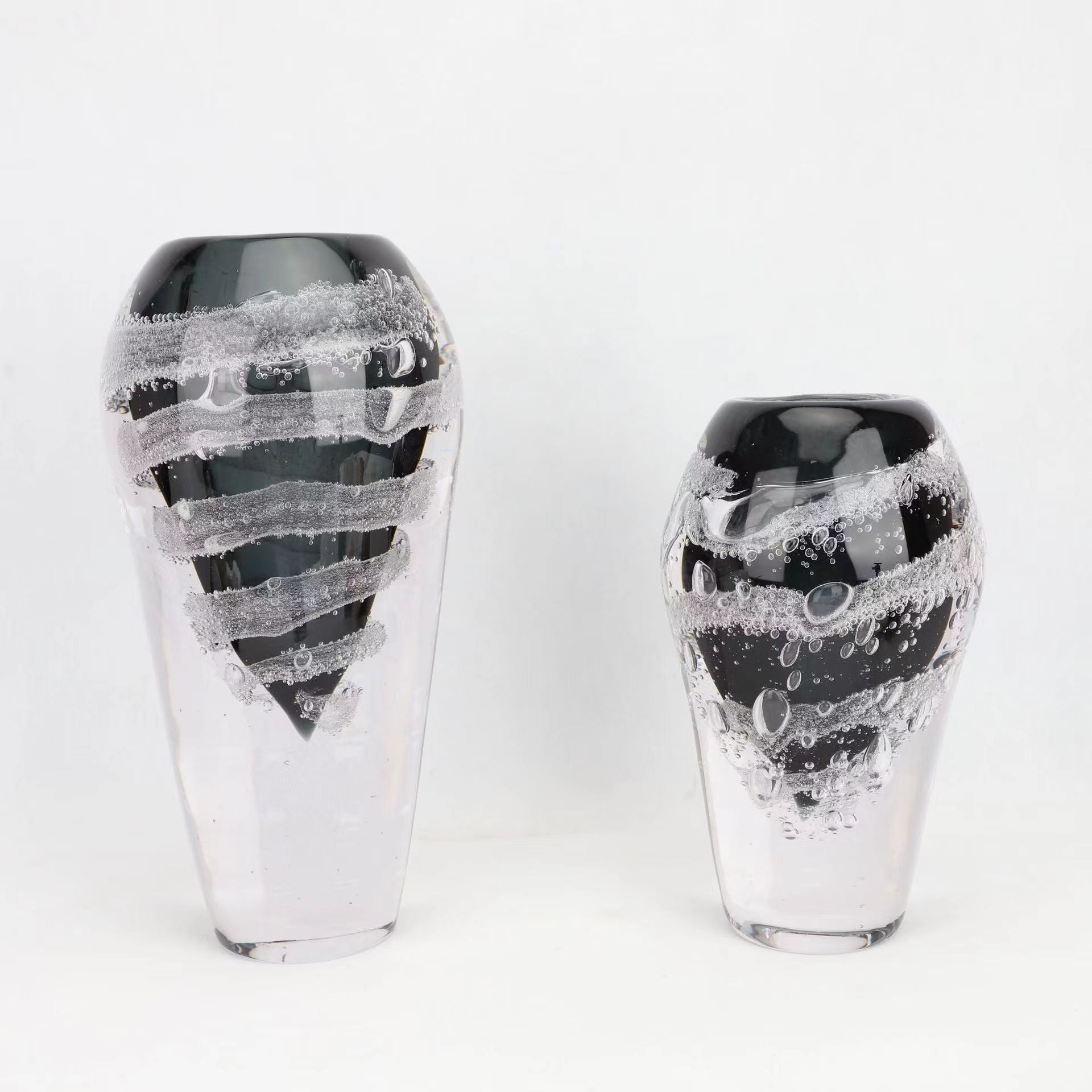 Group of black and clear glass swirl vases
