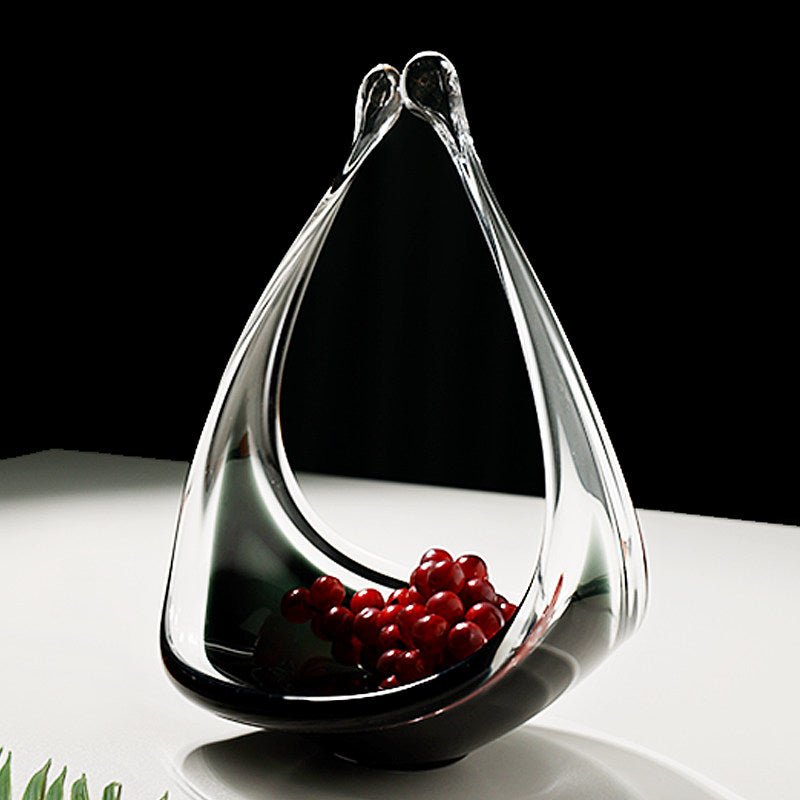 Side view of glass basket holding red fruit