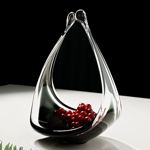 Side view of glass basket holding red fruit