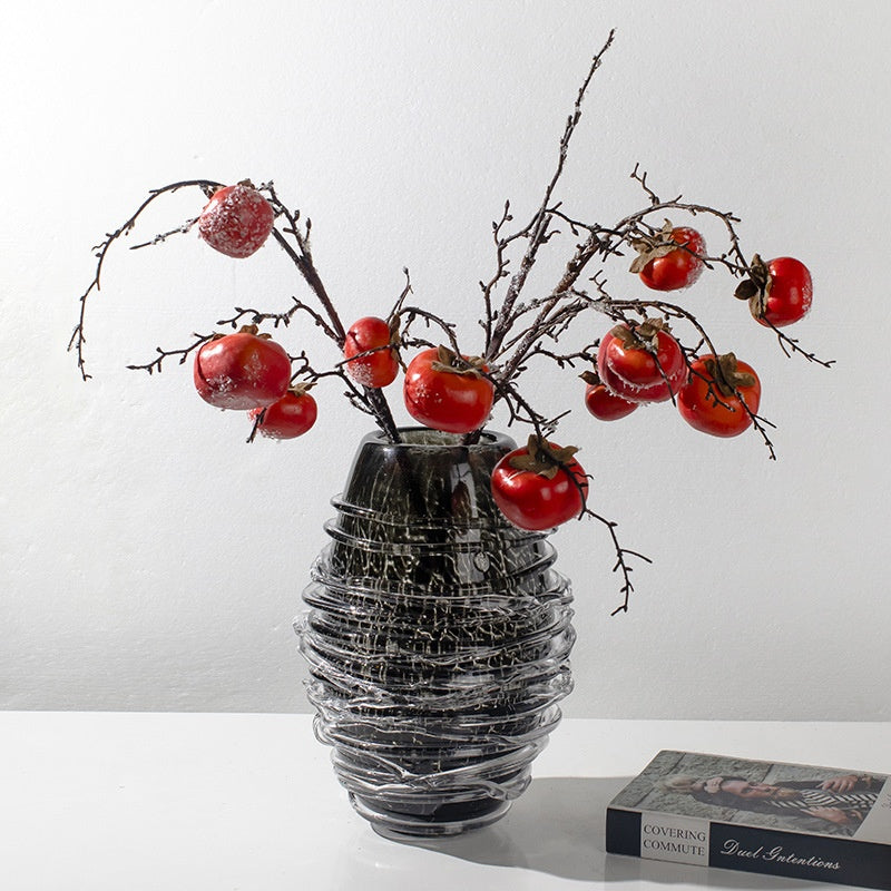 Black spiral wrapped glass vase with red berry branches
