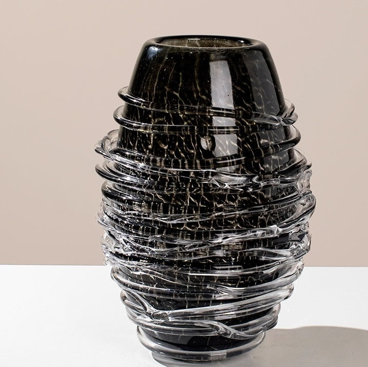 Detail of vase rim and crackle pattern on black glass