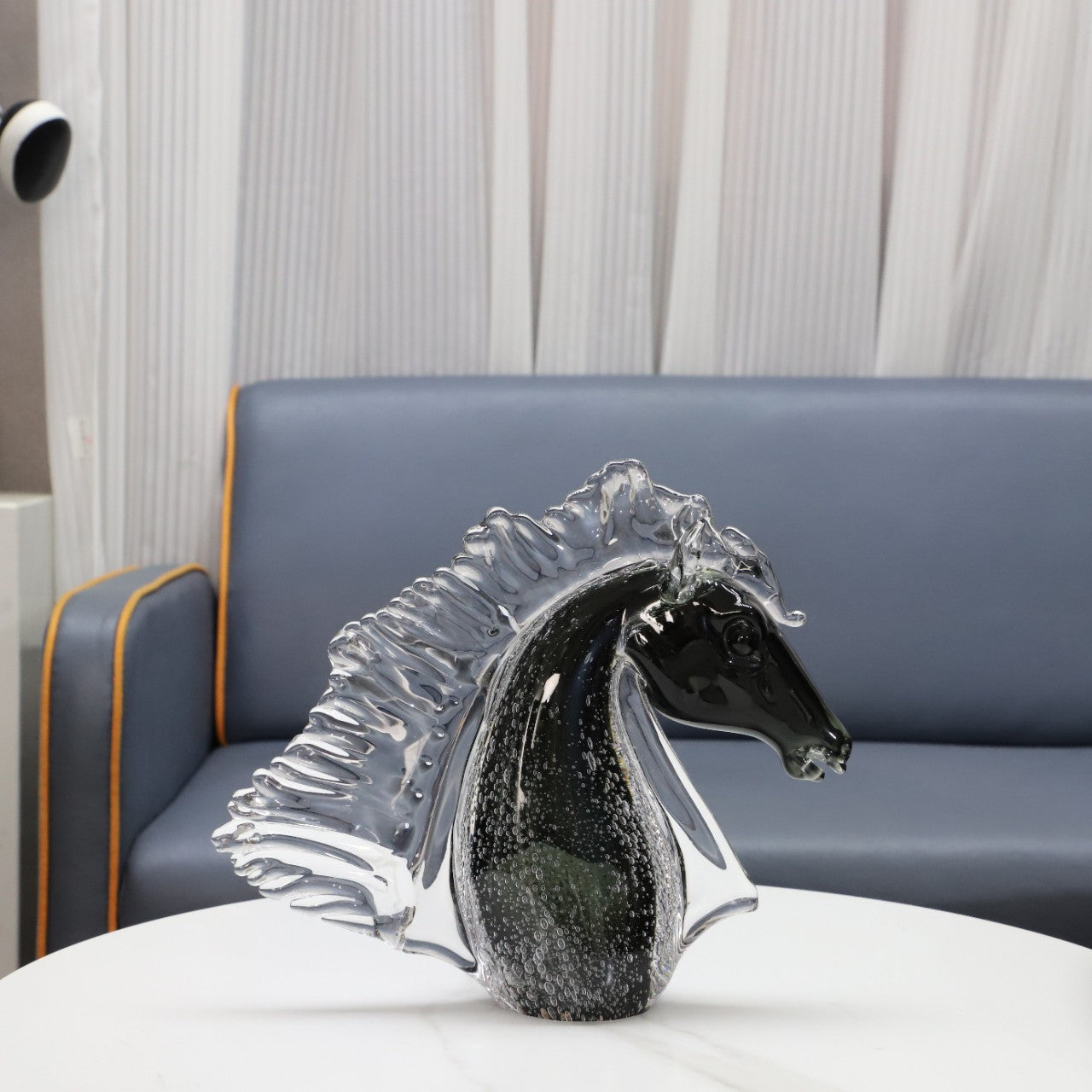 Side profile of black and clear glass horse sculpture