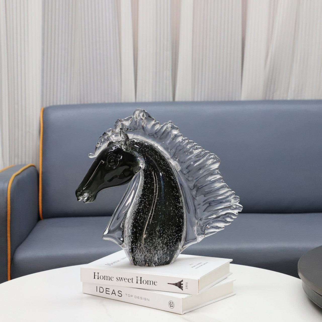 Glass horse sculpture displayed on coffee table